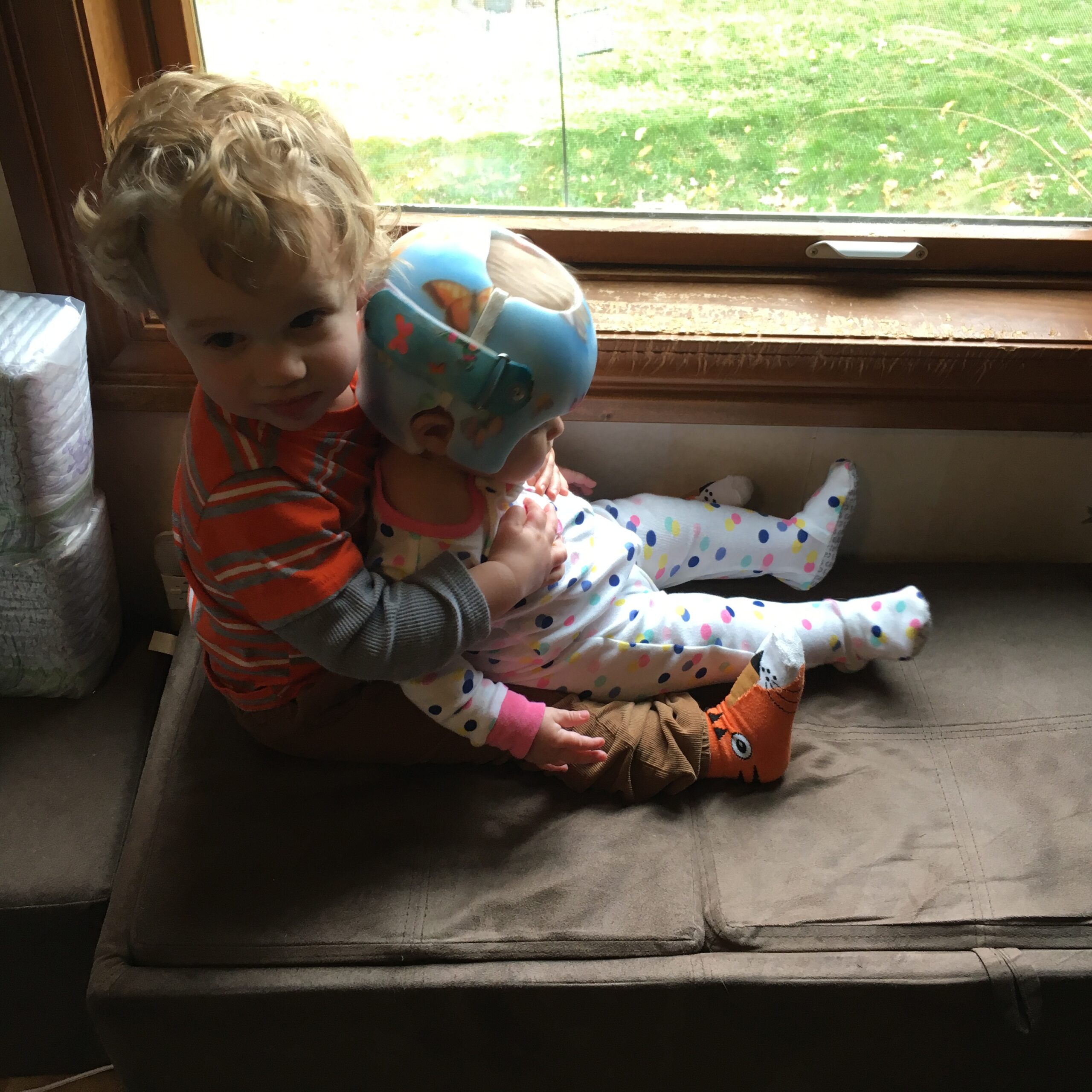 Theo holding Anneliese in their window seat